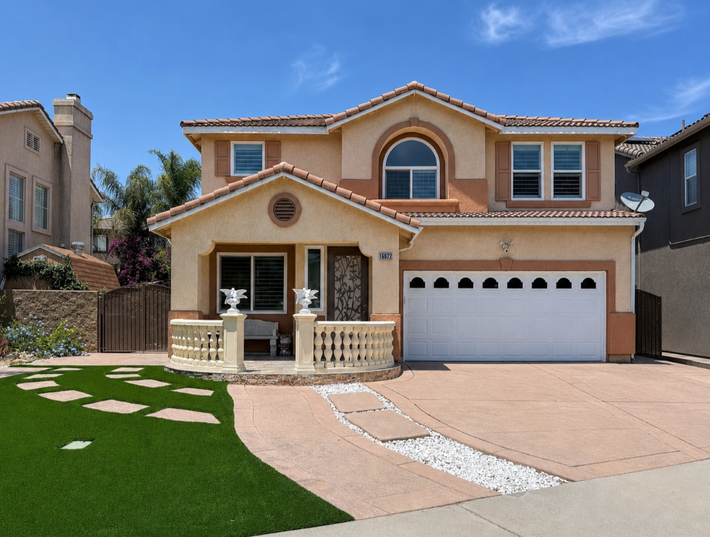 Front exterior — two-story home with covered porch, arched entry window, and tile roof