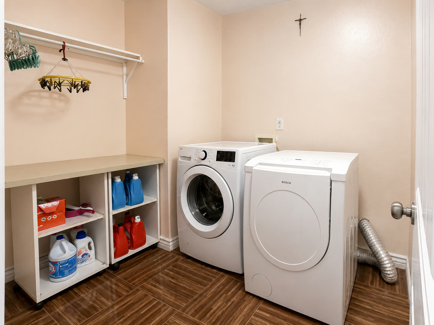 Laundry room with built-in counter, shelving, and hanging rod