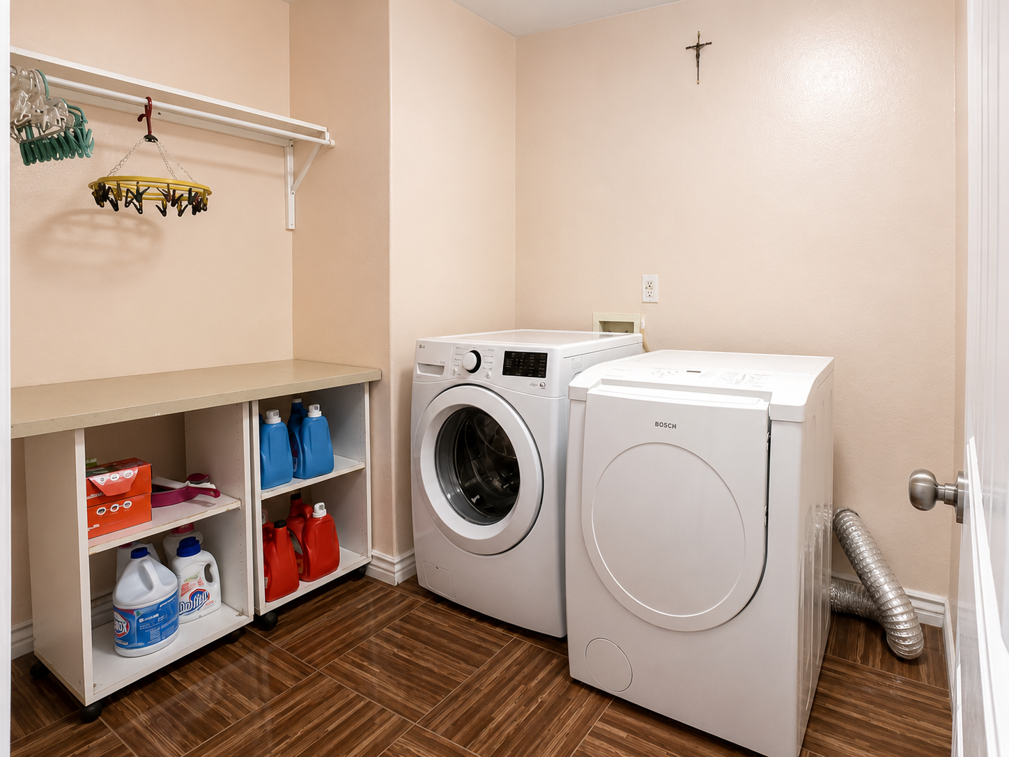 Dedicated laundry room with shelving and hanging rod