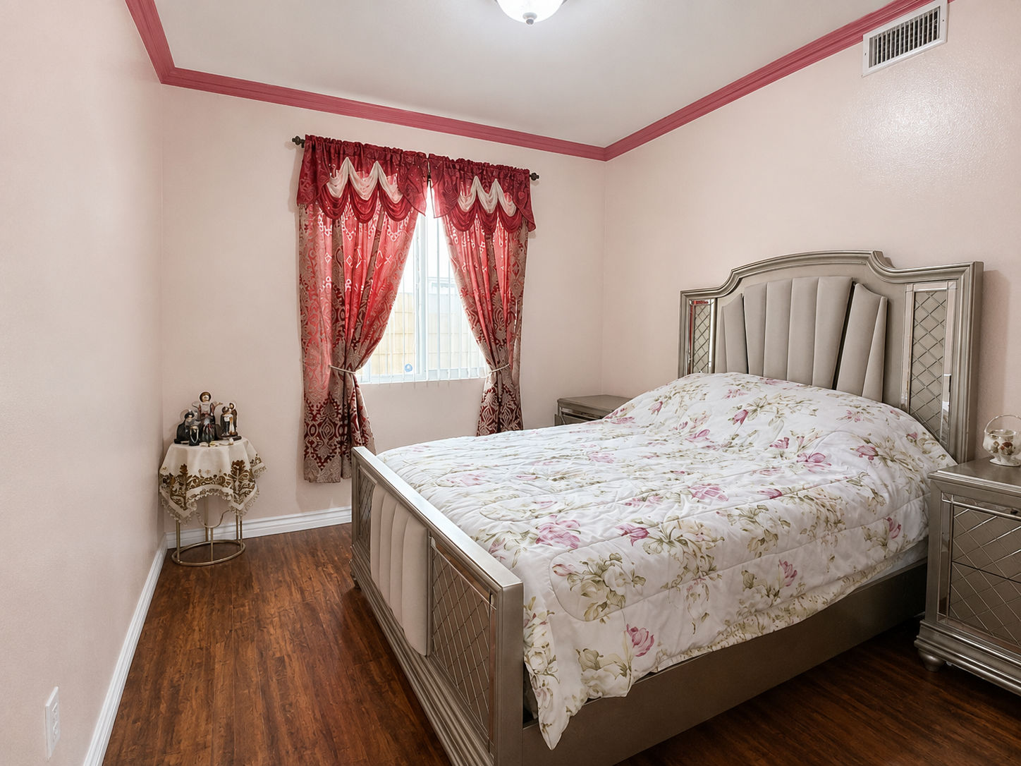 Bedroom with crown molding and laminate flooring