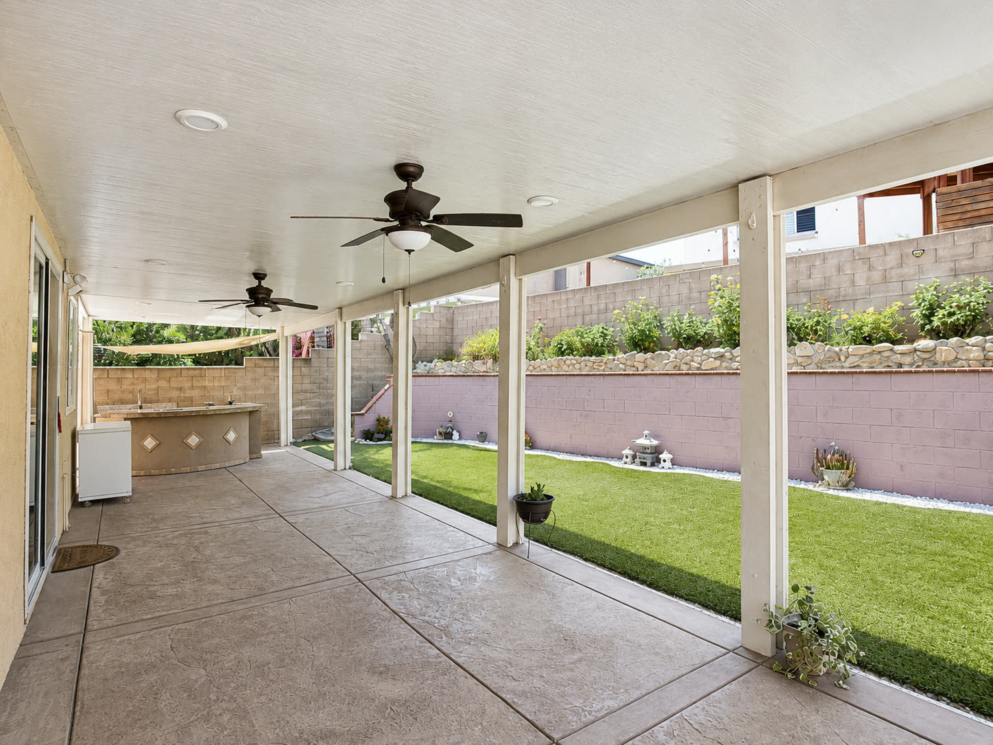 Covered patio with ceiling fans and recessed lighting