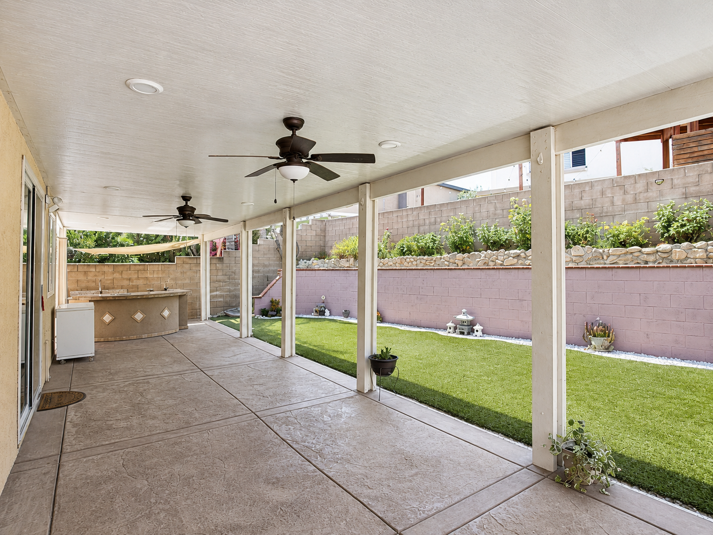 Covered patio with ceiling fans and recessed lighting