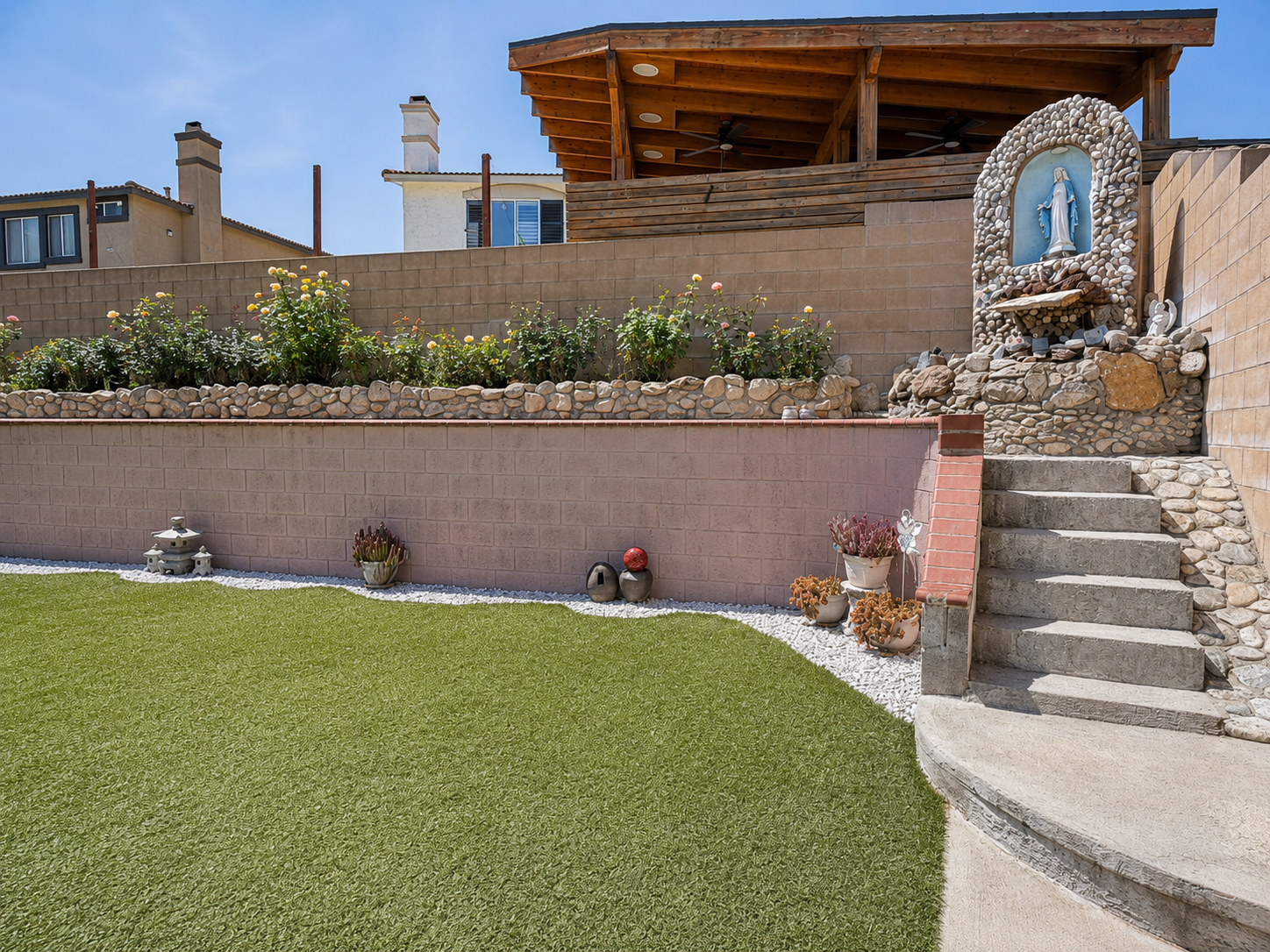 Terraced garden beds with stone accents and steps to the upper terrace