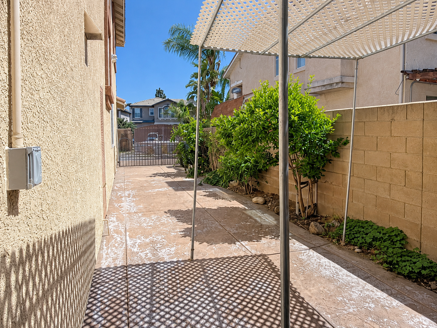 Gated side yard enclosed by block walls