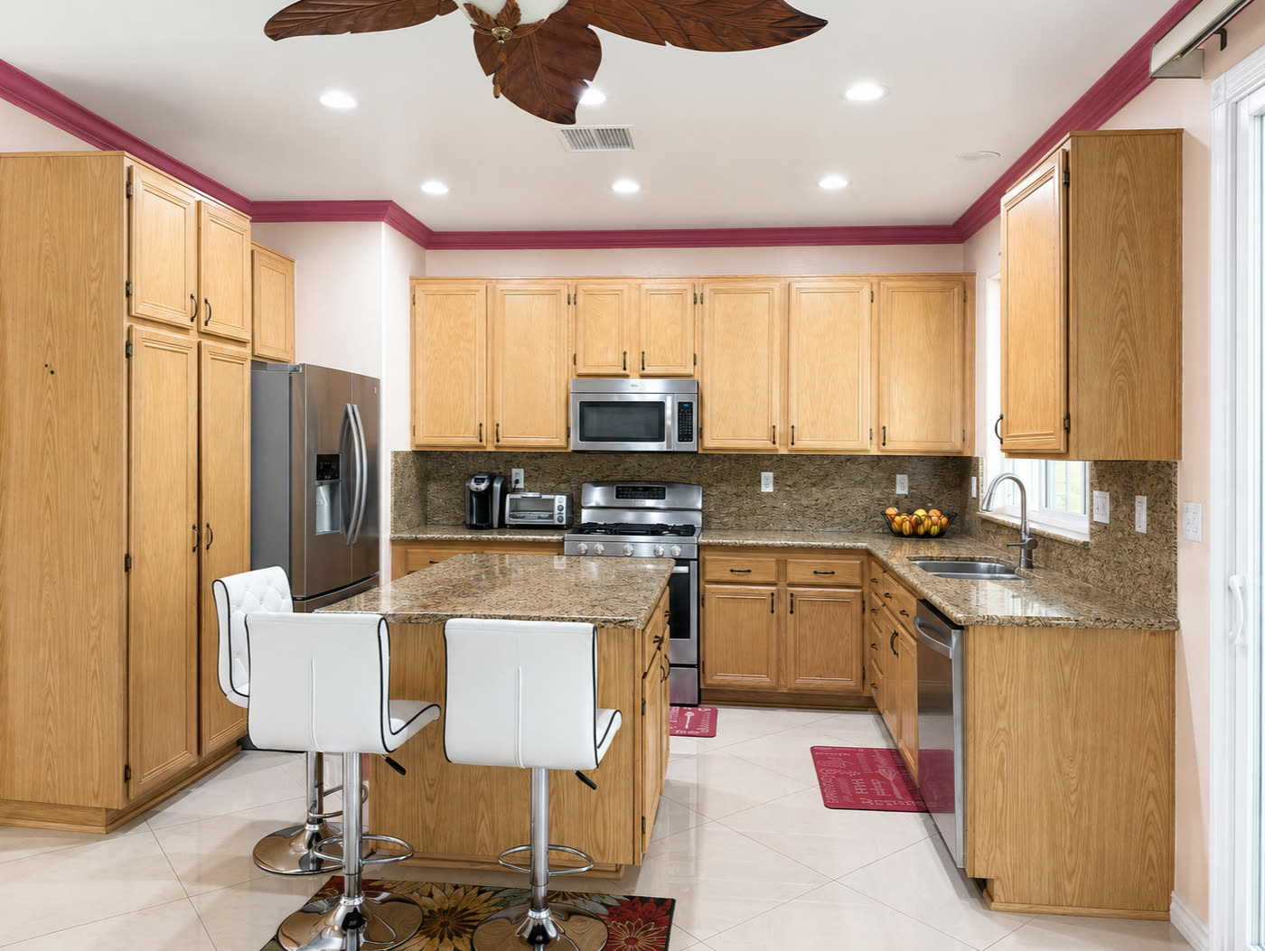Kitchen with granite countertops and backsplash and a center island with bar seating