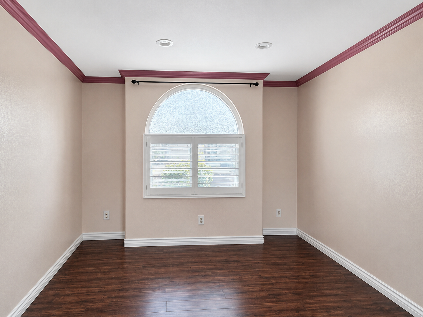 Bedroom with crown molding and laminate flooring